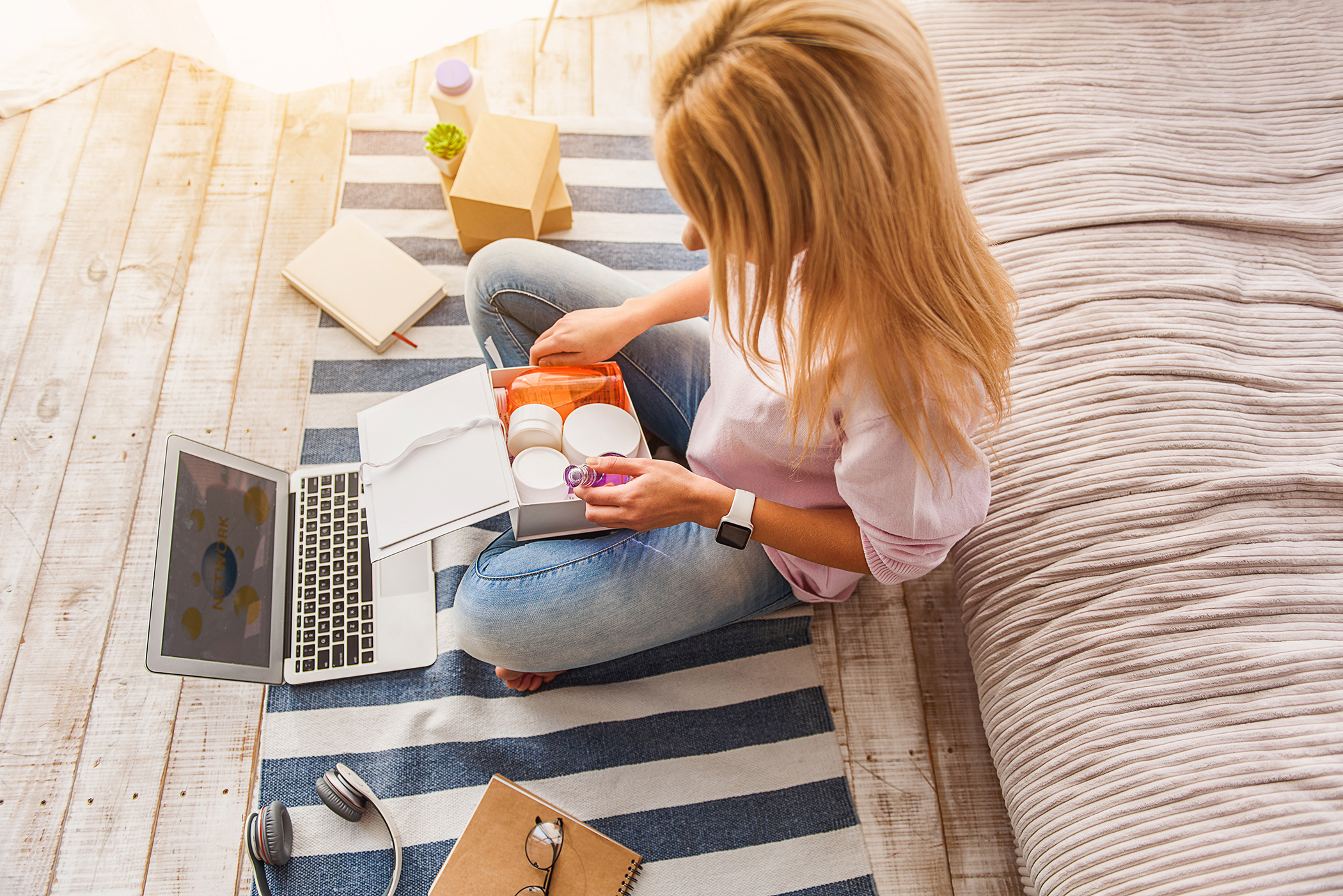 woman opening box of beauty products ordered online for beauty salon website